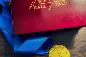 a medal next to a box that reads Alabama Writers Hall of Fame